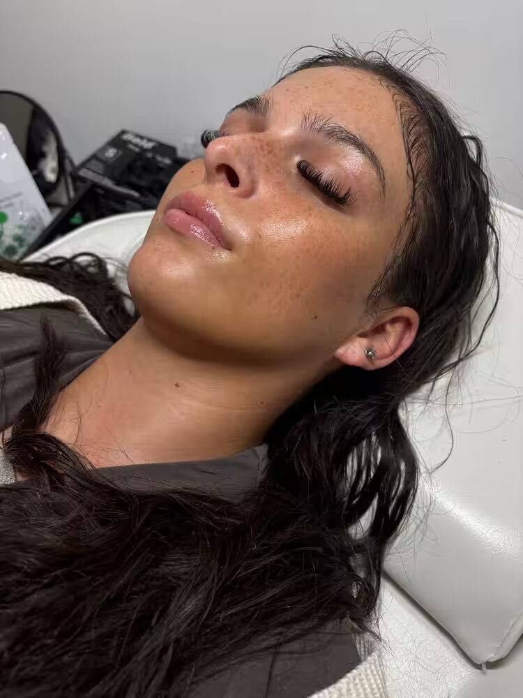 Client with glowing skin after a facial treatment